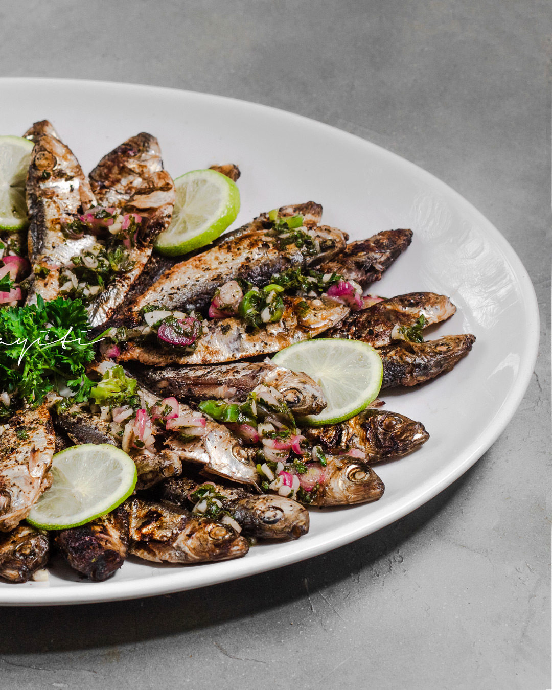 Charcoal grilled sardines with zesty lime hot sauce